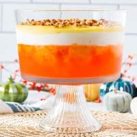 orange supreme in trifle bowl with colorful pumpkin decorations in the background