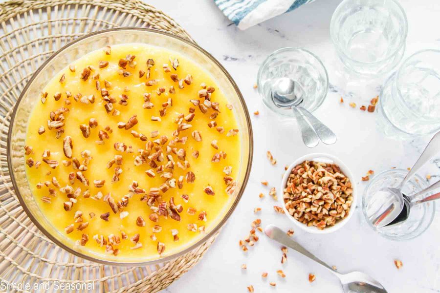 pecan pieces on top of custard layer with parfait cups and spoons