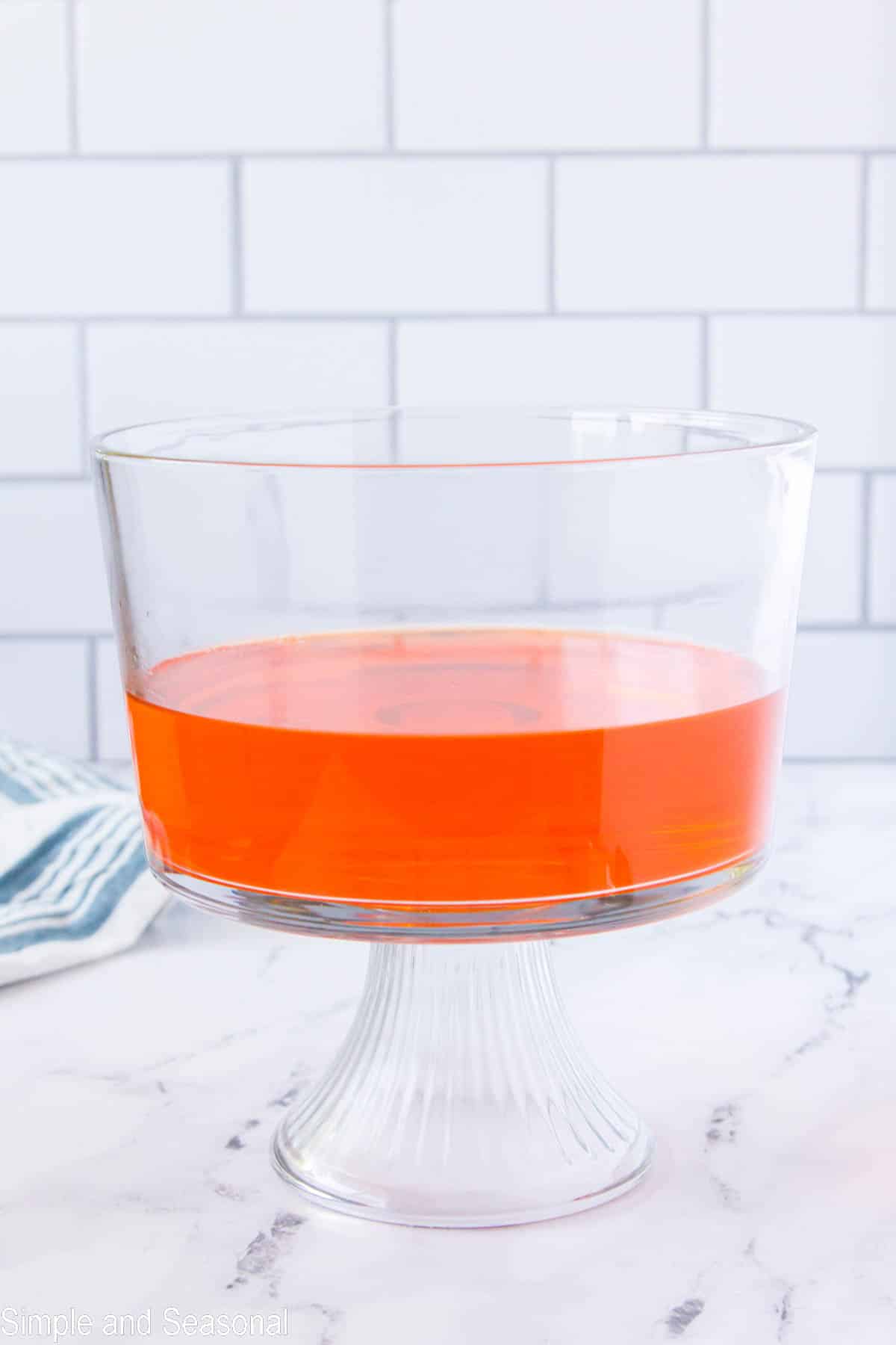 orange jello in a trifle bowl