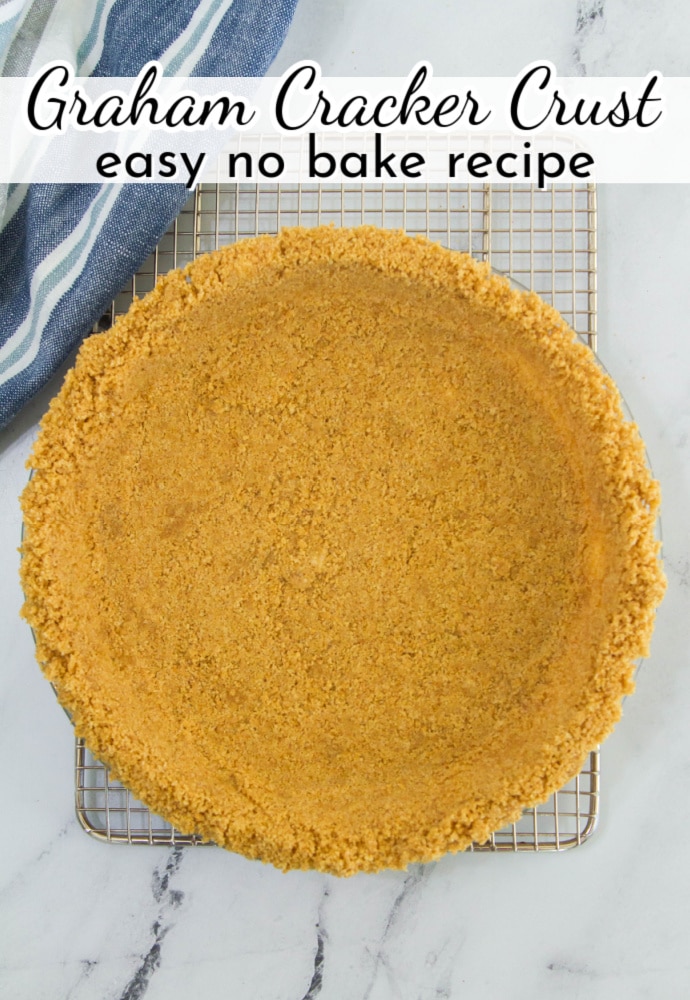 top down view of a pie plate filled with graham crust; text overlay reads Graham Cracker Crust easy no bake recipe.