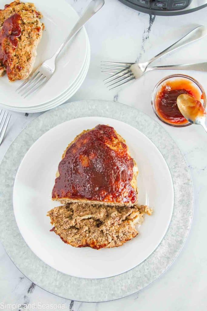 meatloaf on serving platter with extra glaze on the side