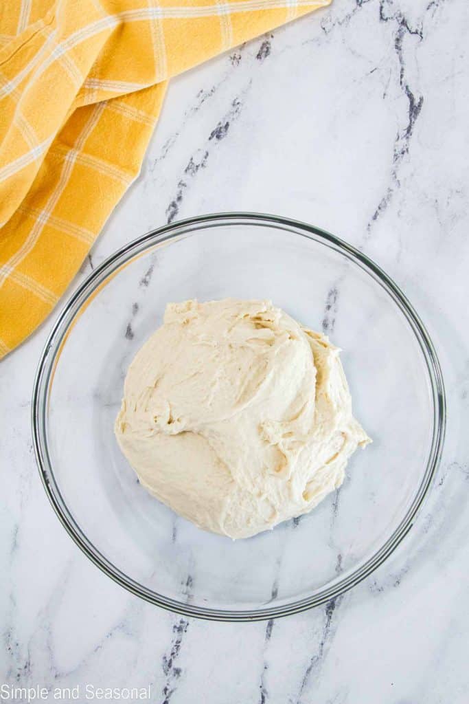 mixed pizza dough in a bowl for rising