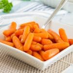 close up of white square bowl filled with pressure cooked carrots