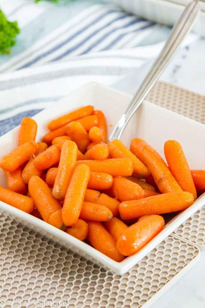 white square bowl with cooked carrots