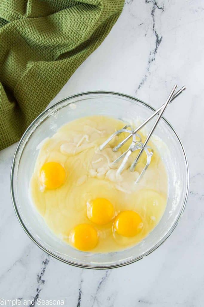 cake mix in bowl with eggs and beaters