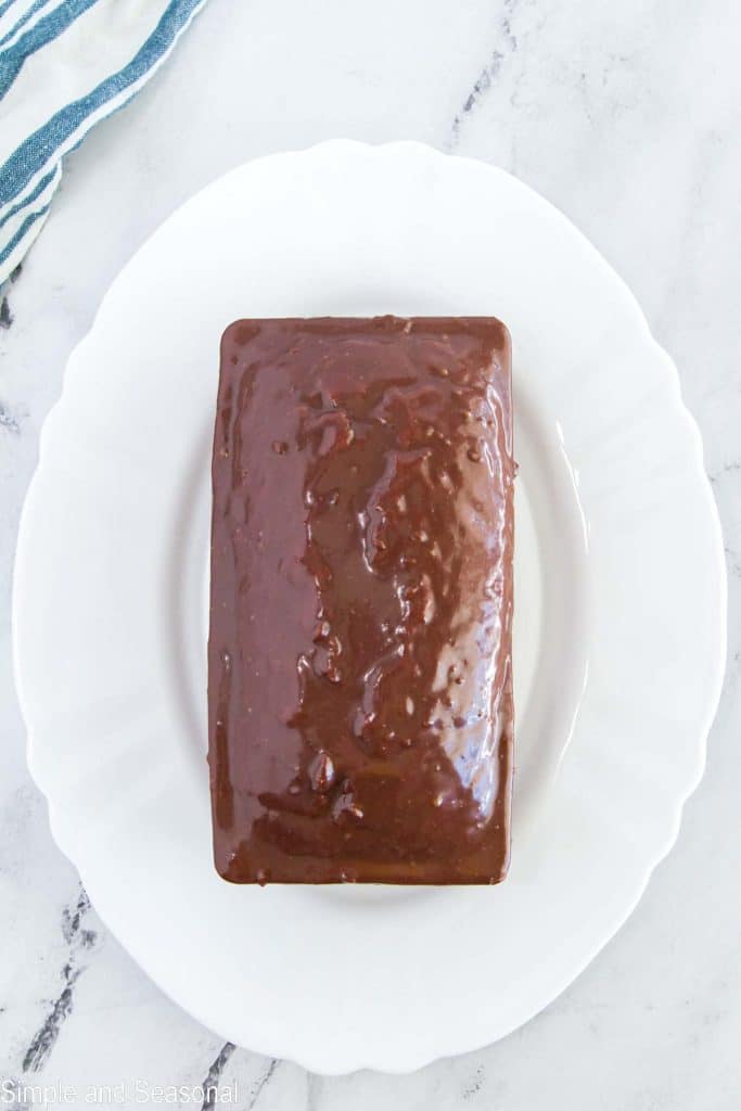 ganache poured over top of loaf of quick bread