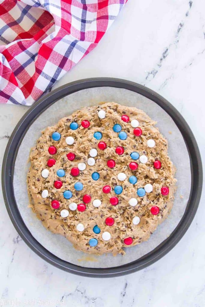 cookie dough spread out and red, white and blue candies added to top