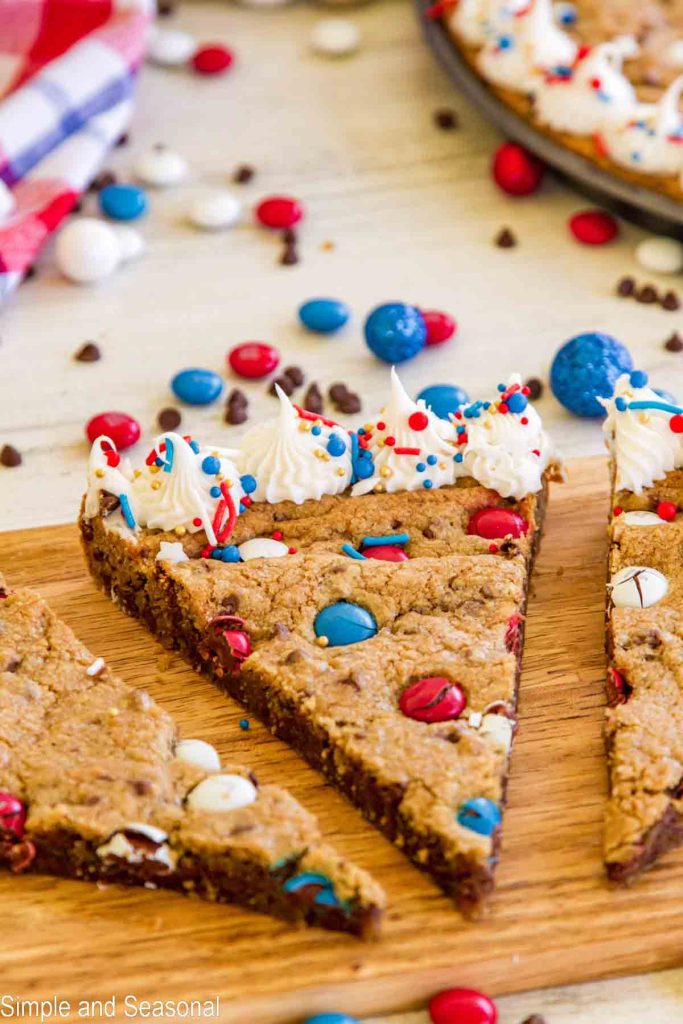 closeup of slice of cookie cake with red and blue candies