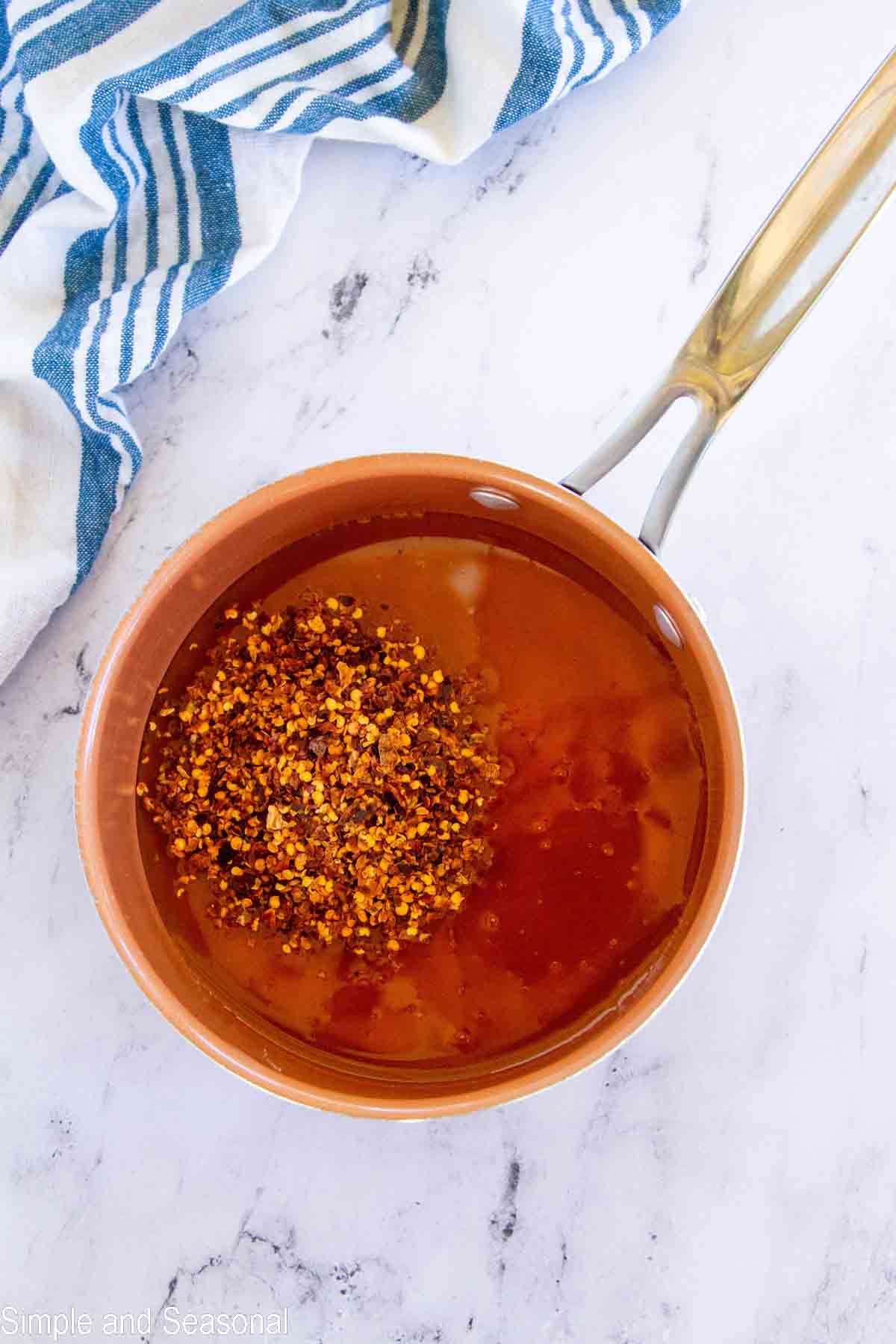 honey and red pepper flakes in a small saucepan