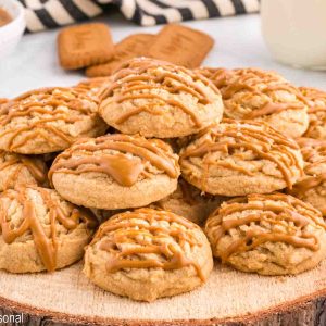 pile of cookies with biscoff and cookie butter in the background