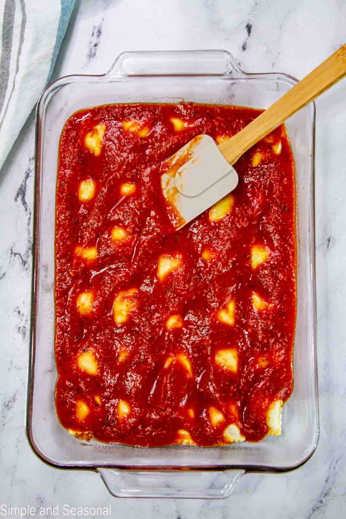 sauce layer over pasta in rectangle pan