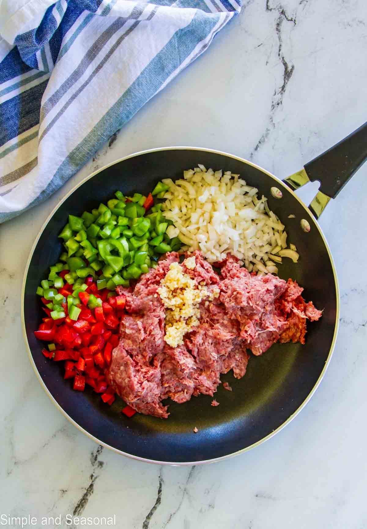 ground beef, red and green peppers, onion and garlic in a skillet