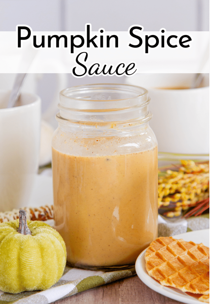 jar of orange sauce or syrup on a table with fall decor; text label reads Pumpkin Spice Sauce