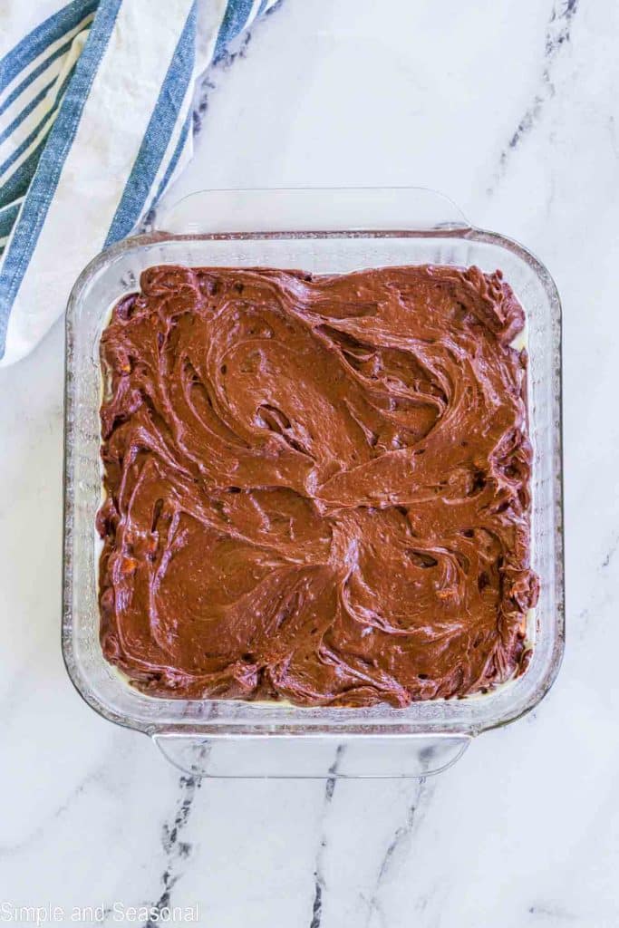 brownie batter in a square baking pan