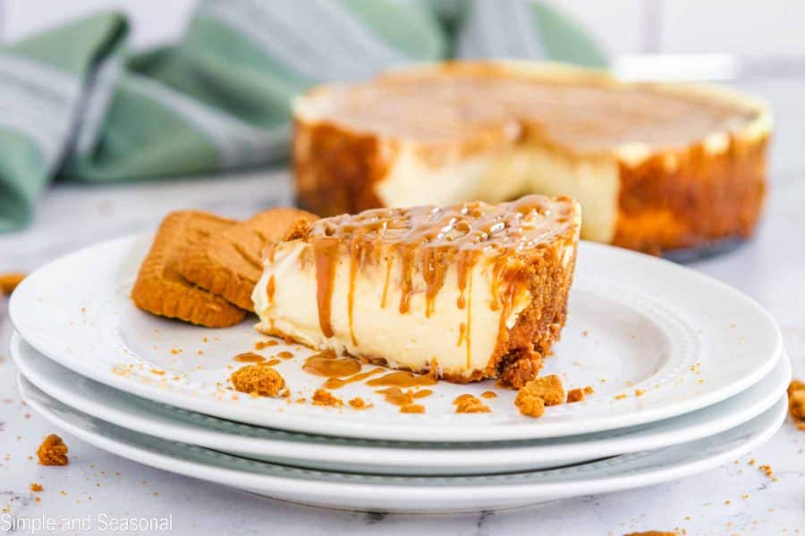 closeup on slice of cheesecake with cookie butter drizzle