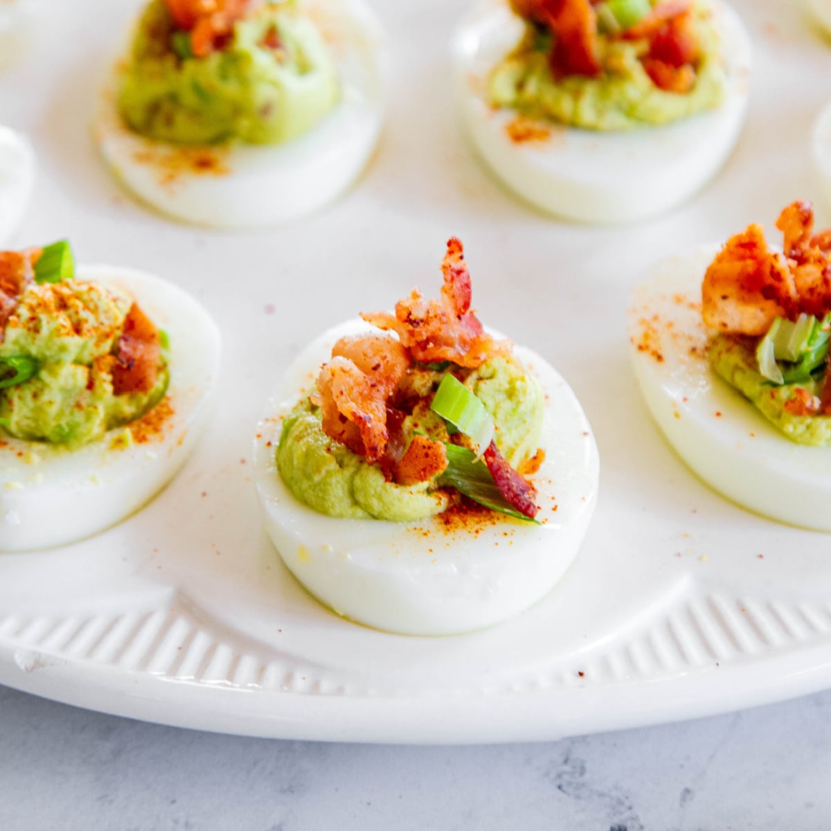 https://simpleandseasonal.com/wp-content/uploads/2023/11/bacon-avocado-deviled-eggs-1200.jpg