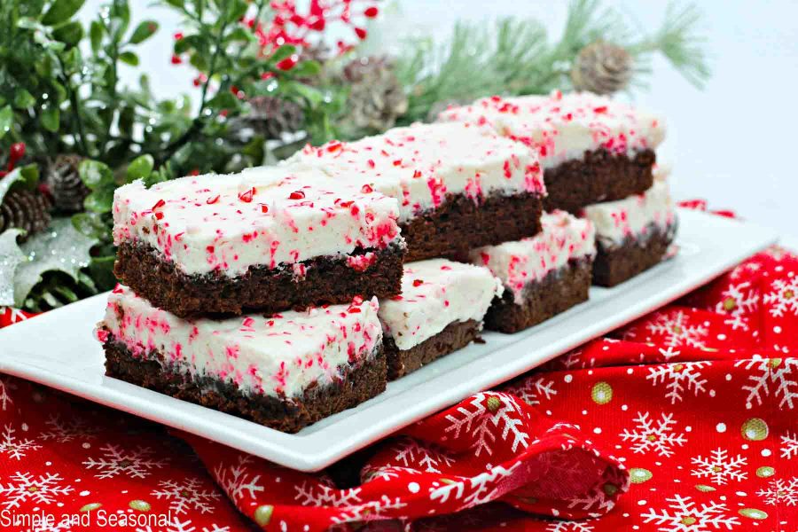 horizontal image of long platter of brownie squares on red Christmas napkin