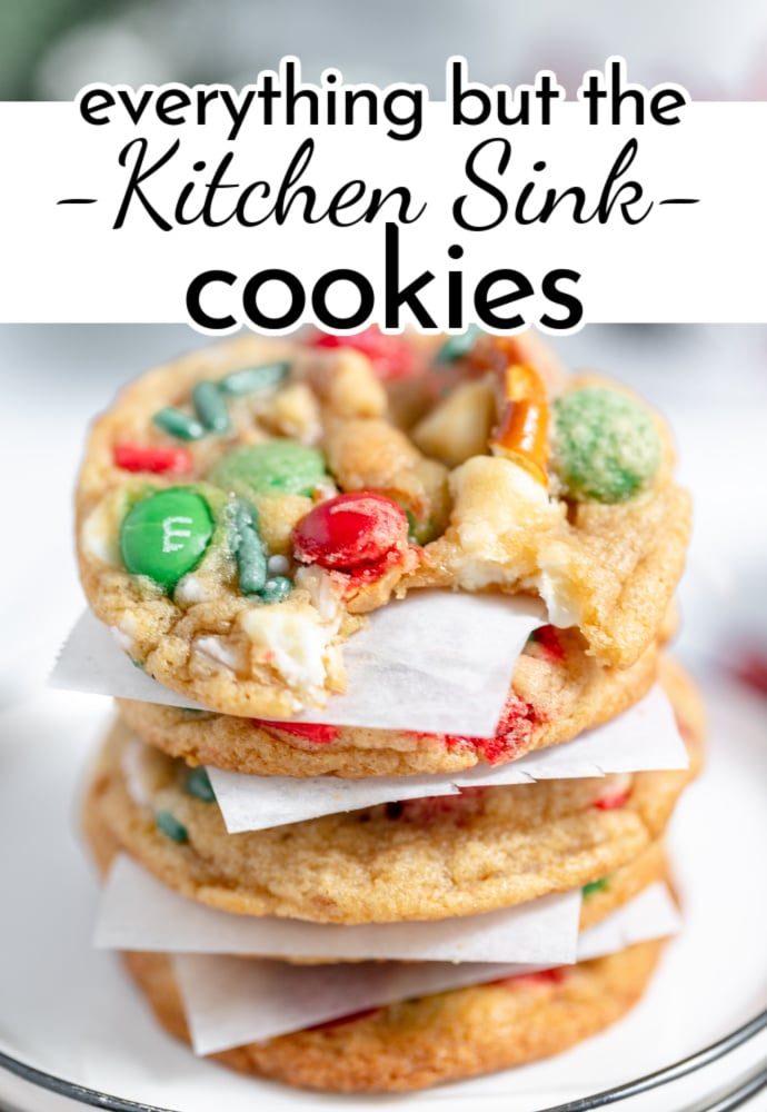 stack of baked cookies separated wity parchment squares; text label reads Everything but the Kitchen Sink Cookies