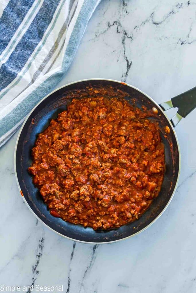 cooked ground beef in a tomato sloppy joe sauce in the pan