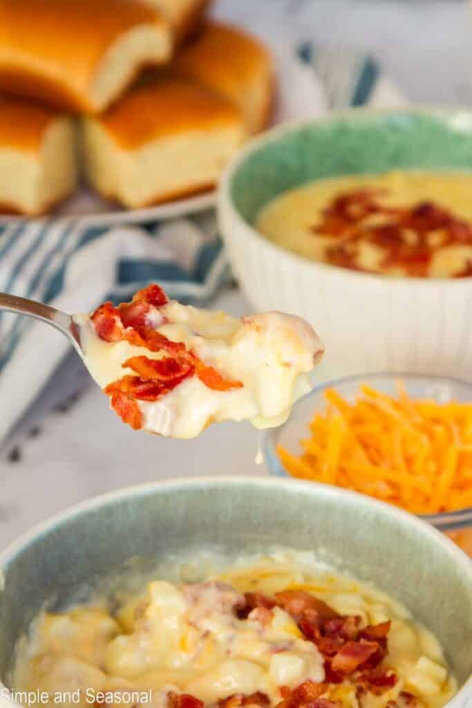 shows spoonful of cheesy potato soup