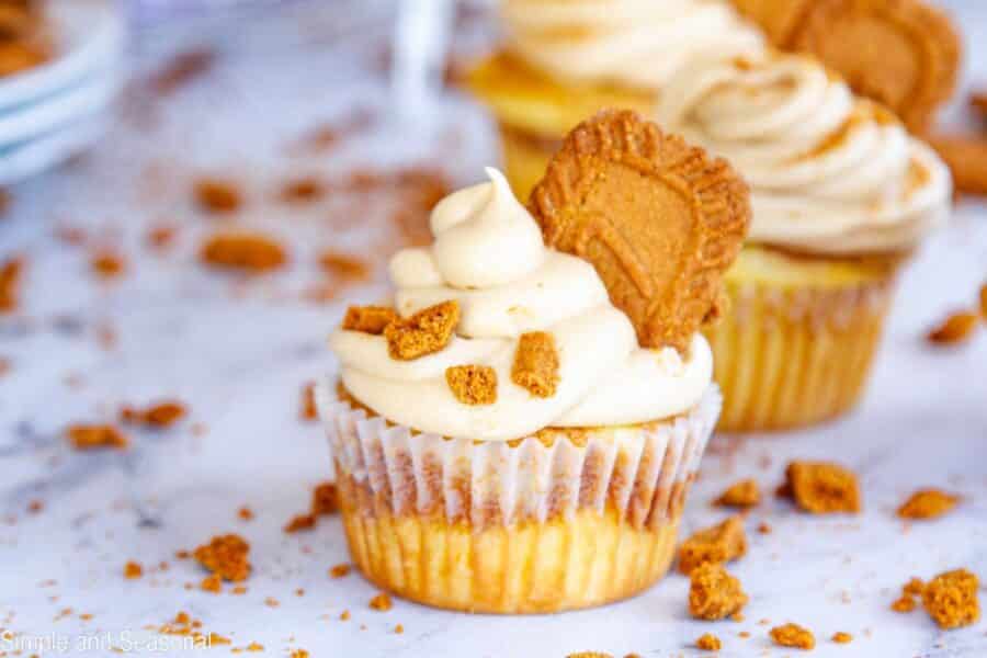 biscoff cupcake topped with homemade frosting and sprinkled with cookie crumbles