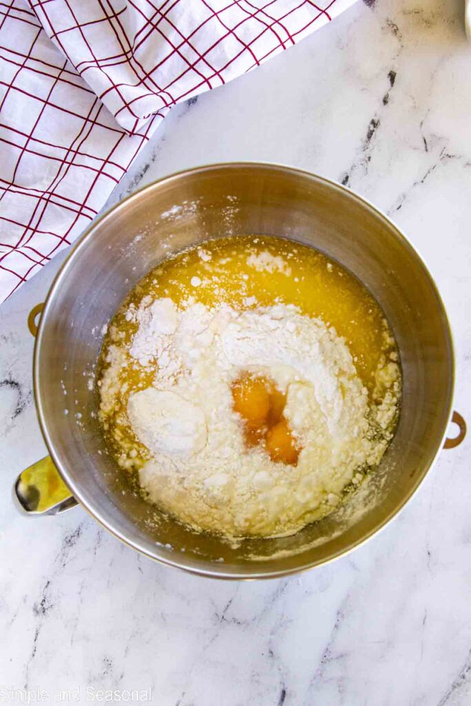 cake mix, butter, eggs and milk in a metal mixing bowl