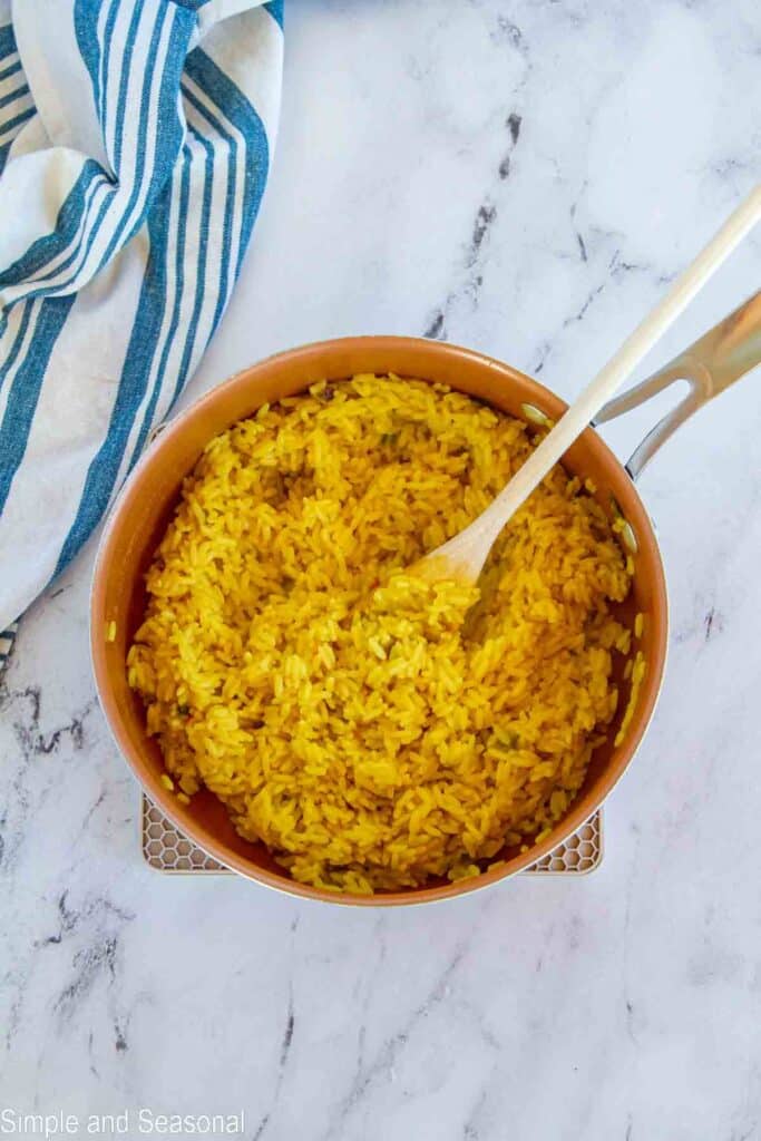 cooked yellow rice in a saucepan