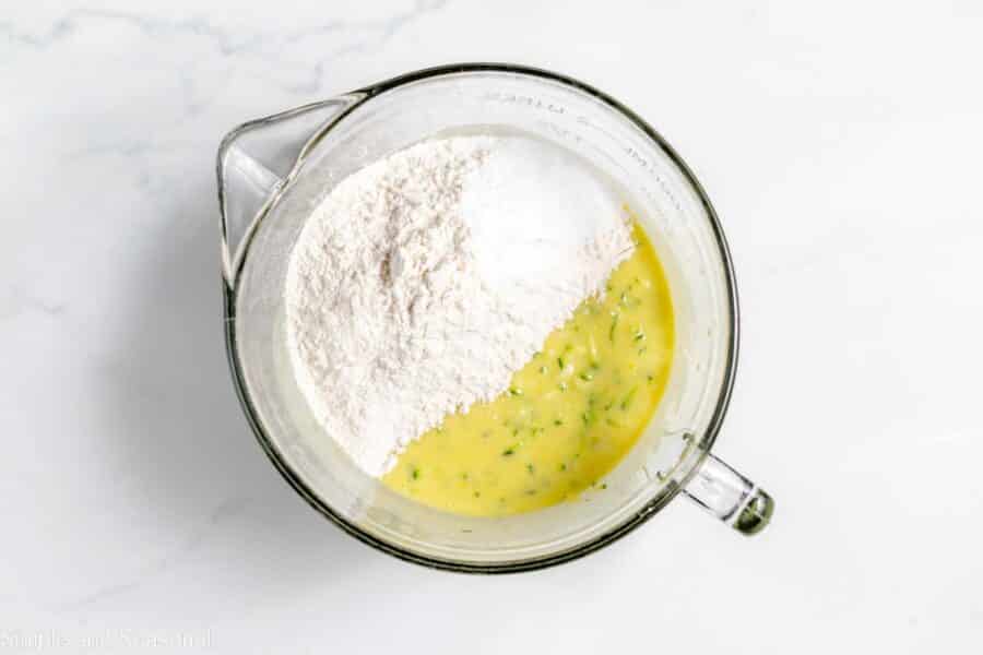 flour and baking soda (dry ingredients) added to the wet in a mixing bowl