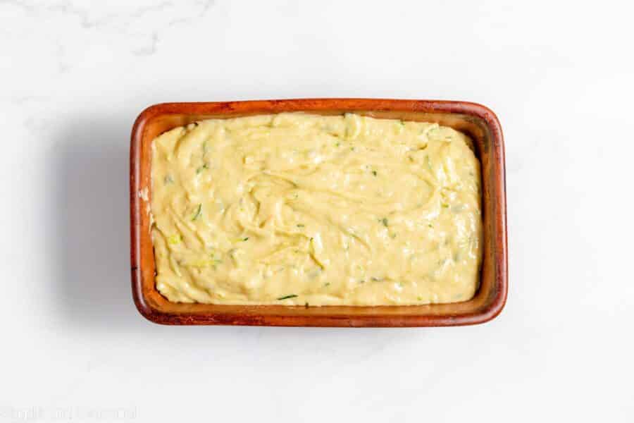 zucchini bread batter in a loaf pan