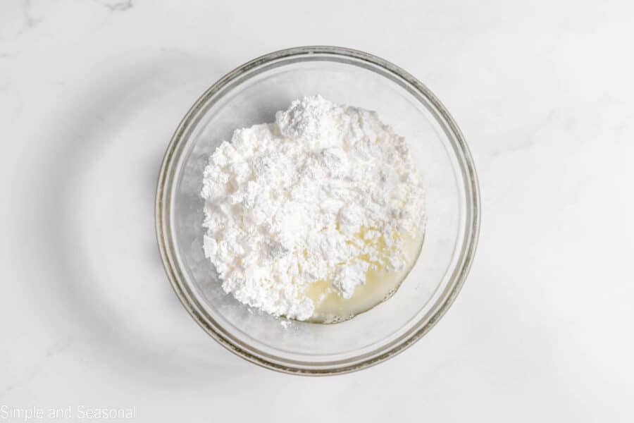 powdered sugar and lemon juice in a mixing bowl