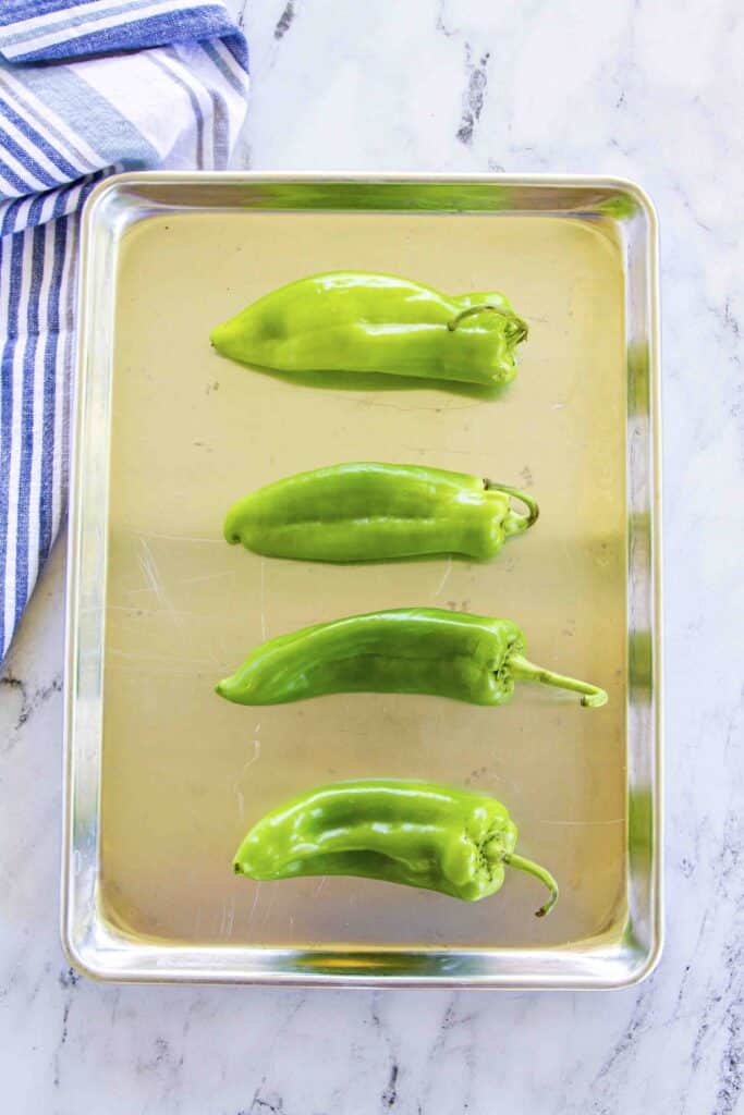 raw peppers on a sheet pan