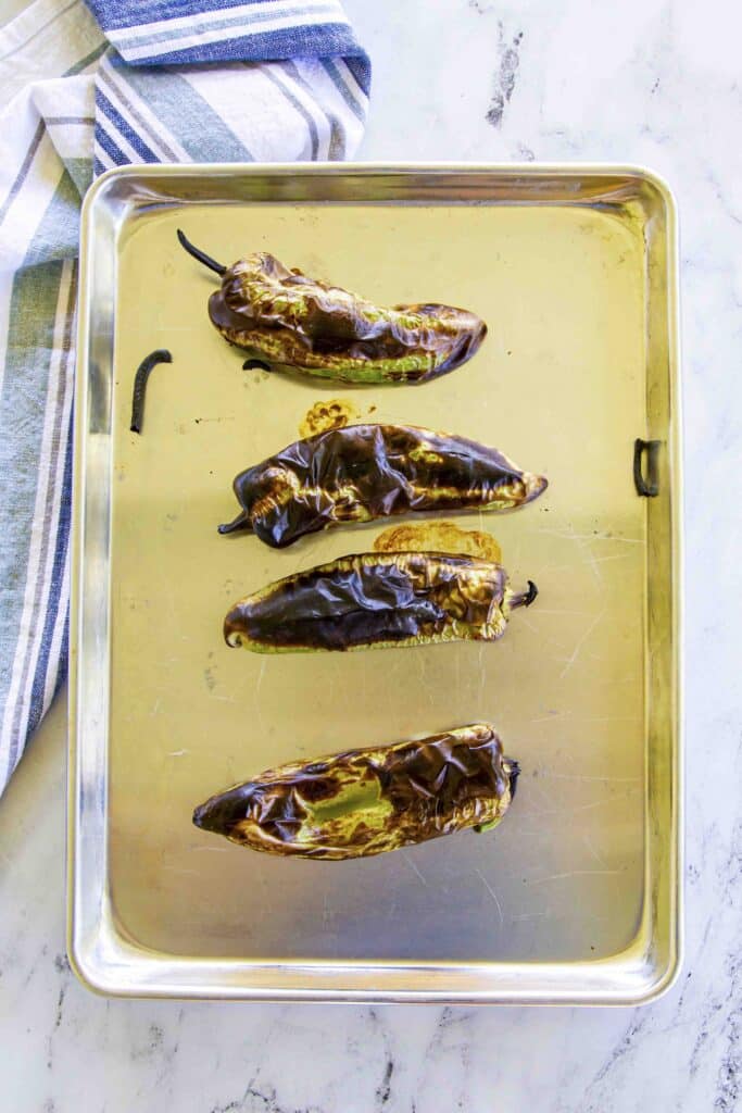 blackened and blistered peppers on the sheet pan