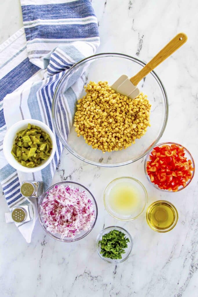 cut up and cooked ingredients ready to mix into corn salad