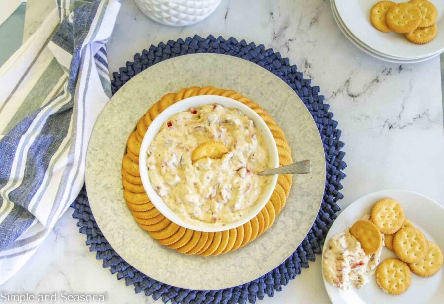 top down view of platter with crackers and bowl of dip