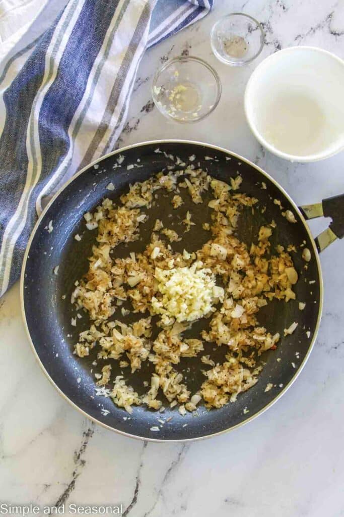 cooked onion with seasonings and garlic in a skillet