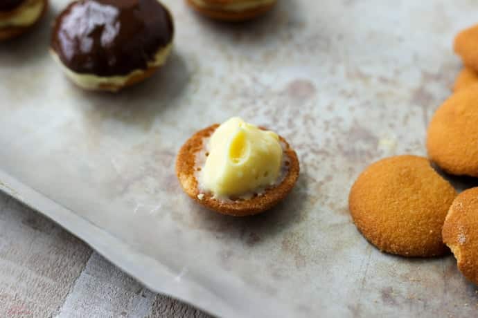 one wafer cookie topped with a small amount pudding filling