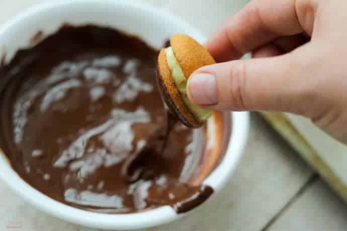 removing excess chocolate dipping from cookie top