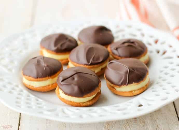 plate full of pudding filled, chocolate dipped cookies