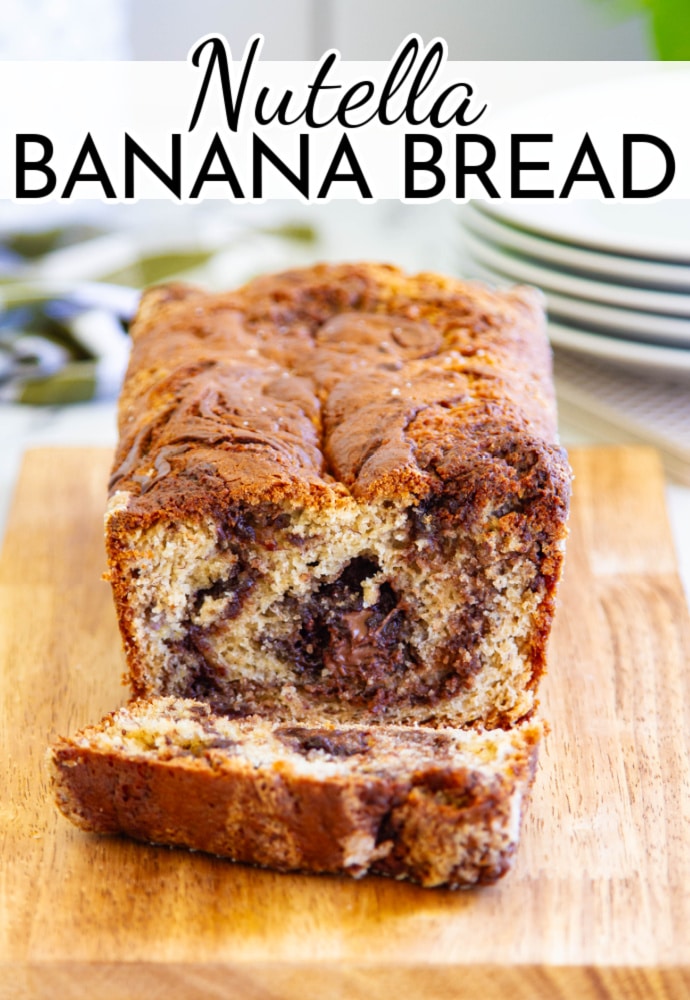 loaf of bread on a cutting board with one slice removed to show the inside; text label reads Nutella Banana Bread