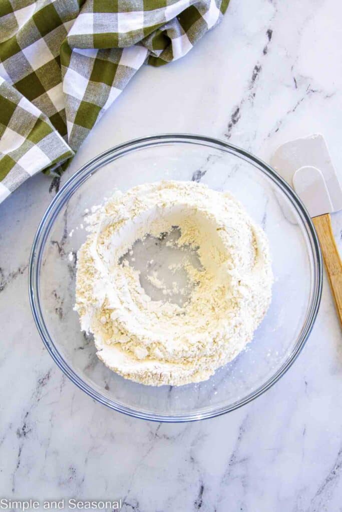 well in center of dry ingredients in a mixing bowl