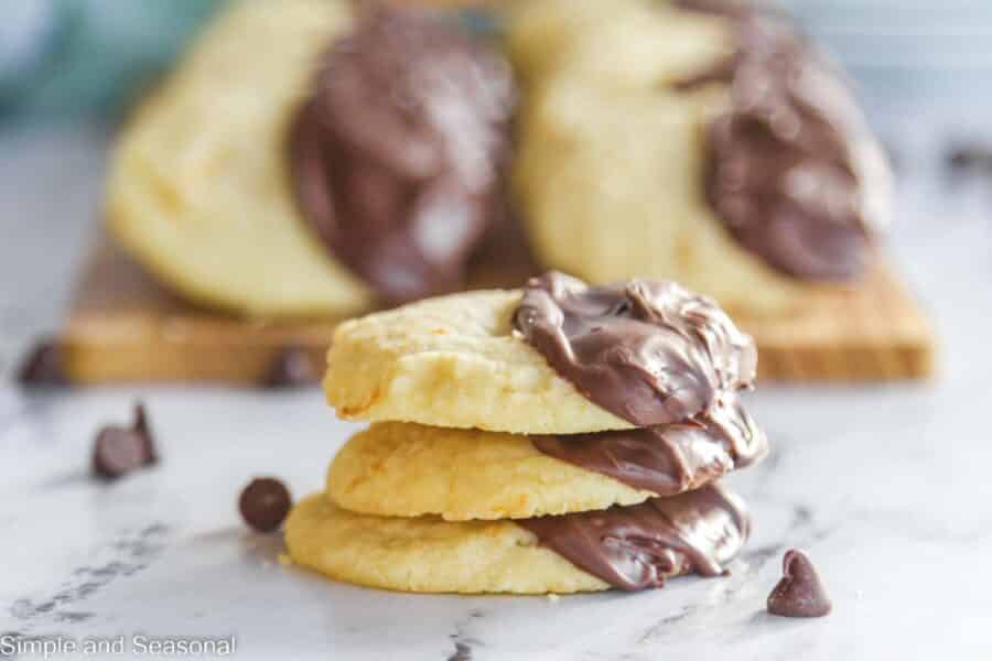 chocolate dipped orange butter cookies on a counter