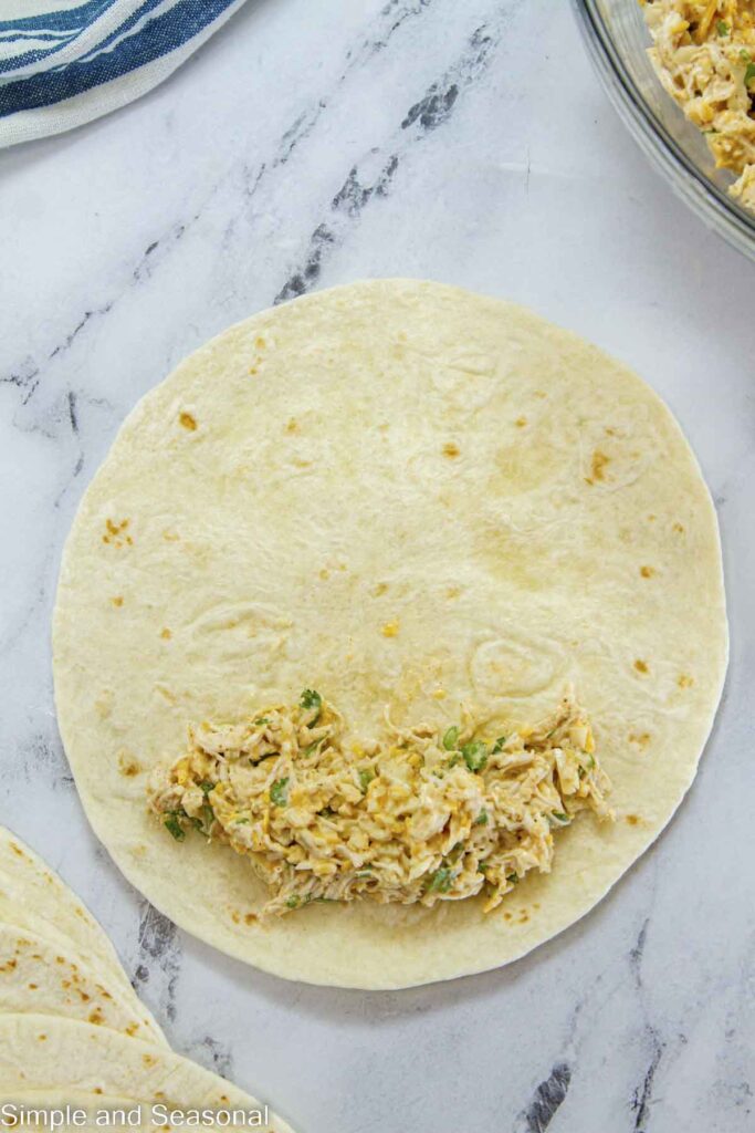 chicken taquito filling on a flour tortilla