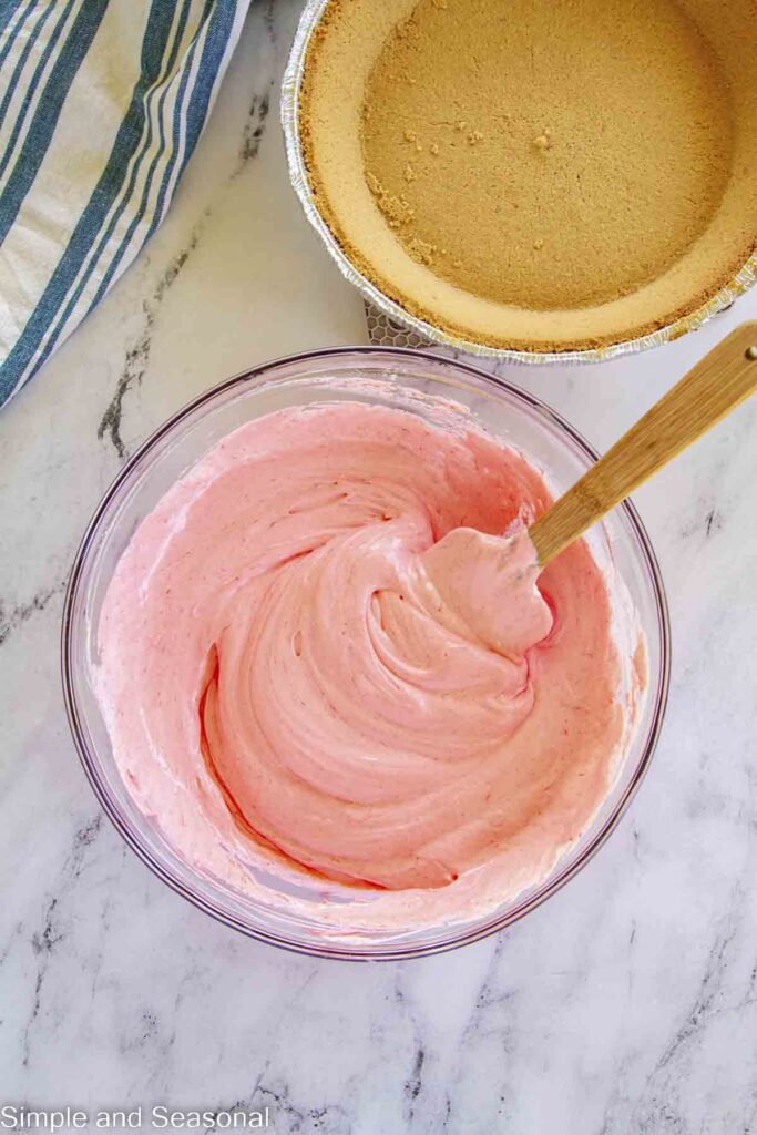 smooth, mixed pie filling in a mixing bowl with a spatula