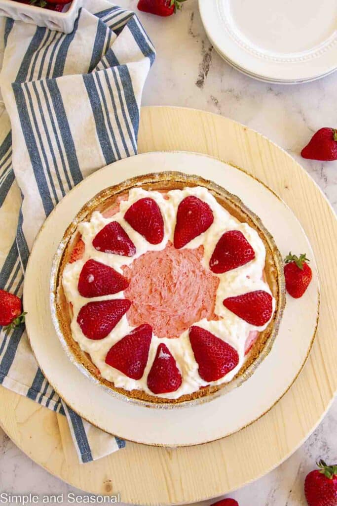 top down view of kool-aid pie decorated with whipped cream and strawberries