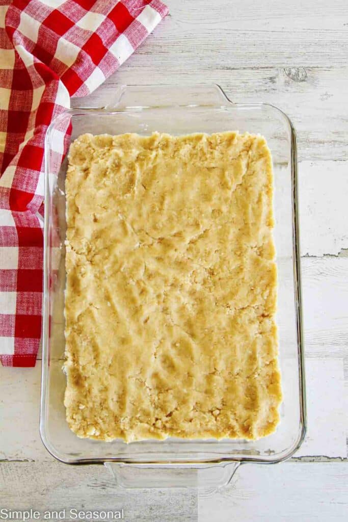 cookie dough pressed down into 9x13 baking pan