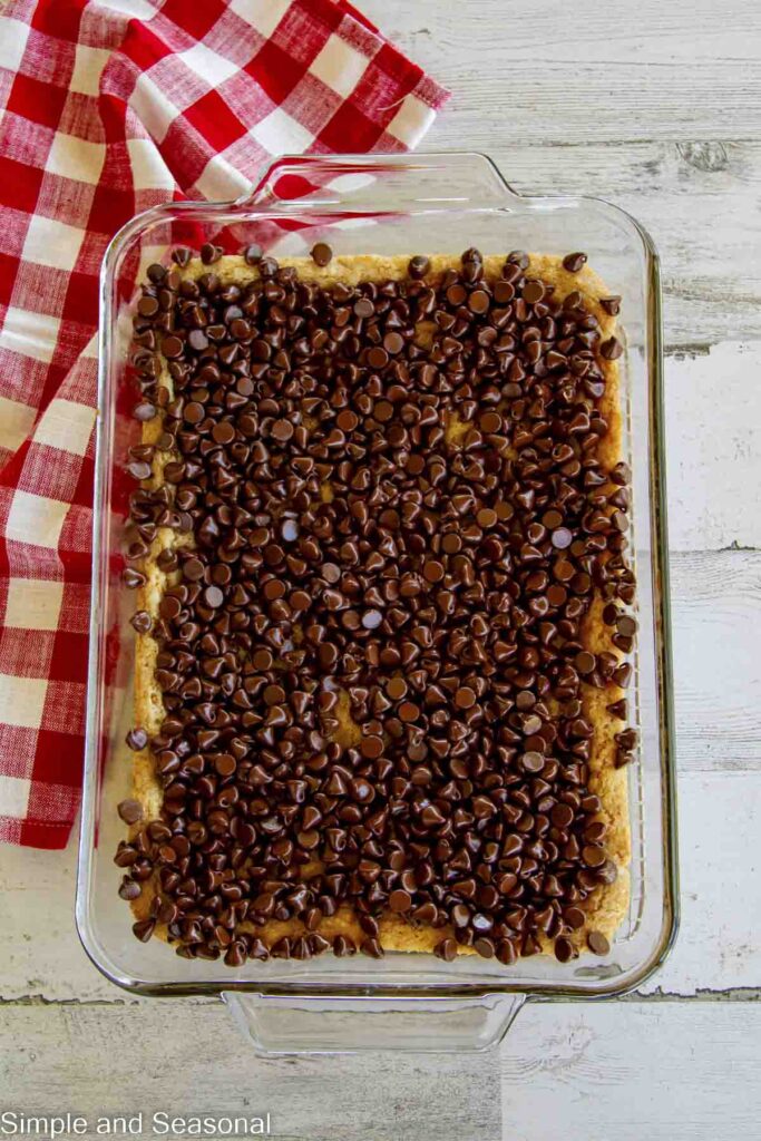 chocolate chips placed on freshly baked cookie layer