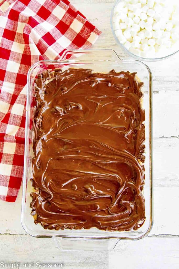 melted chocolate spread over cookie layer base