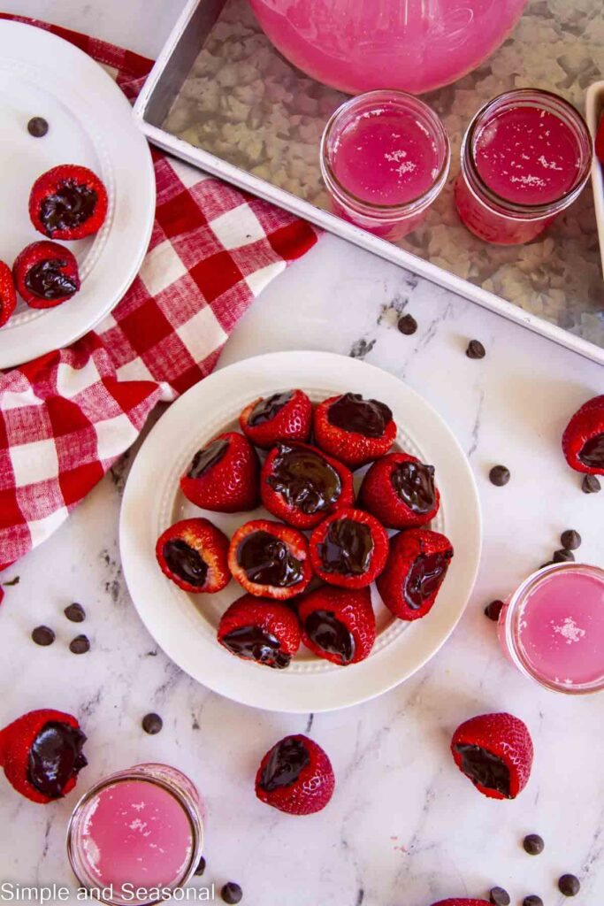 plate of strawberries filled with chocolate and platter of pink lemonade