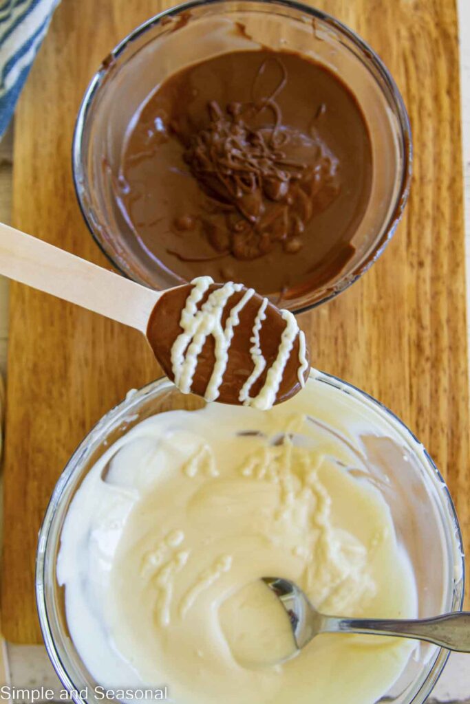white chocolate drizzled over milk chocolate spoon