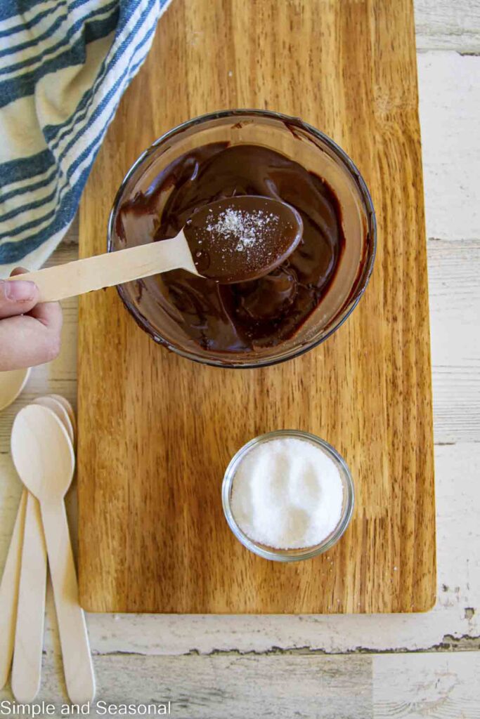 salt sprinkled on top of dark chocolate spoon